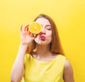 Happy young woman holding a half orange Royalty Free Stock Photo