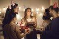 Happy young woman holding her birthday cake and thanking friends for the surprise and the presents Royalty Free Stock Photo