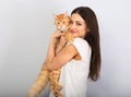 Happy young woman holding and hugging with love on the hands her red maine coon kitten and kissing. Closeup Royalty Free Stock Photo