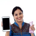 Happy young woman holding Indian currency and mobile phone Royalty Free Stock Photo