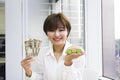 Happy young woman holding Japanese Yen and toy car Royalty Free Stock Photo