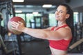 Happy young woman holding medicine ball in gym Royalty Free Stock Photo