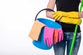 Happy young woman holding a mop and a bucket filled with cleaning products isolated on white background Royalty Free Stock Photo