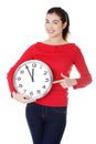 Happy young woman holding office clock Royalty Free Stock Photo