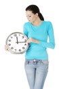 Happy young woman holding office clock Royalty Free Stock Photo