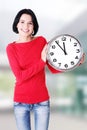 Happy young woman holding office clock Royalty Free Stock Photo