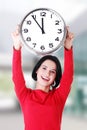 Happy young woman holding office clock Royalty Free Stock Photo