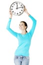 Happy young woman holding office clock Royalty Free Stock Photo