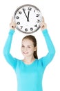 Happy young woman holding office clock Royalty Free Stock Photo