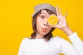 Happy young woman holding orange halves