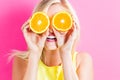 Happy young woman holding orange halves