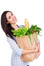 Happy young woman holding paper bag with groceries Royalty Free Stock Photo