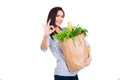 Happy young woman holding paper bag with groceries Royalty Free Stock Photo