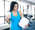 Happy young woman holding plastic container at gym Royalty Free Stock Photo