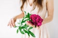 Happy young woman holding red peony in hands. Sweet romantic moment Royalty Free Stock Photo