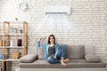 Woman Relaxing Under The Air Conditioner