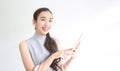 Happy young woman holding shopping bags and mobile phone. Makes online shopping on a tablet. Female shopping through online stores Royalty Free Stock Photo