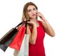 Happy young woman holding shopping bags and mobile phone over white background Royalty Free Stock Photo