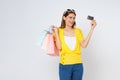 Happy young woman holding shopping bags and showing credit card isolated on white background Royalty Free Stock Photo