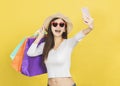 Happy young woman holding shopping bags and watching the mobile phone Royalty Free Stock Photo