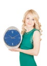 Happy young woman with horror looks at an clock on a white background. Royalty Free Stock Photo