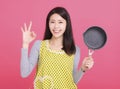 Happy young woman housewife Wearing Kitchen Apron and showing ok gesture