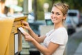 Woman Inserting Letter In Mailbox Royalty Free Stock Photo