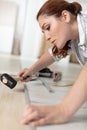 happy young woman installing laminate flooring in new apartment Royalty Free Stock Photo