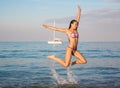 Happy young woman in jump on beach Royalty Free Stock Photo