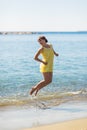 Happy young woman jump on the beach of sea Royalty Free Stock Photo