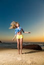 Happy young woman jumping on beach Royalty Free Stock Photo