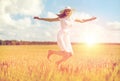 Happy young woman jumping on cereal field Royalty Free Stock Photo