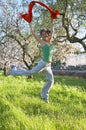 Happy young woman jumping on a field Royalty Free Stock Photo