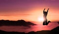 Happy Young Woman Jumping For Joy On The Peak of Mountain Sunset Landscape . Free Successful Female Jumps in Top Mountain Royalty Free Stock Photo