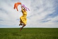 Happy young woman jumping for joy on a wheat field Royalty Free Stock Photo
