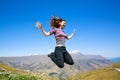 Happy Young woman jumping with Mt Aspiring landscape view in Wanaka, New Zealand Royalty Free Stock Photo