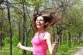 Happy young woman jumping with a skipping rope in a summer park Royalty Free Stock Photo