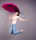 Happy young woman jumping with umbrella Royalty Free Stock Photo