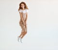 Happy young woman jumping on white background