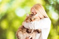 Happy young woman kissing and hugging a siberian cat Royalty Free Stock Photo