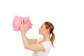 Happy young woman kissing a piggybank Royalty Free Stock Photo