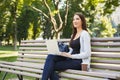 Happy young woman with laptop outdoors Royalty Free Stock Photo