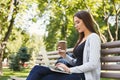 Happy young woman with laptop outdoors Royalty Free Stock Photo