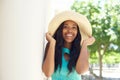 Happy young woman laughing and holding sun hat Royalty Free Stock Photo