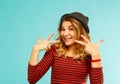 Happy young woman laughing loudly over blue background