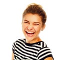 Happy young woman laughing loudly over white background