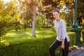 Happy young woman laughing posing in summer park. College student with bag walking and having fun