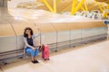 happy young woman listening music with headphones and taking selfie with mobile phone at the airport Royalty Free Stock Photo