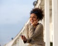 Happy young woman listening to music on mobile phone Royalty Free Stock Photo