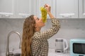 Happy young woman eating grapes in a kitchen Royalty Free Stock Photo